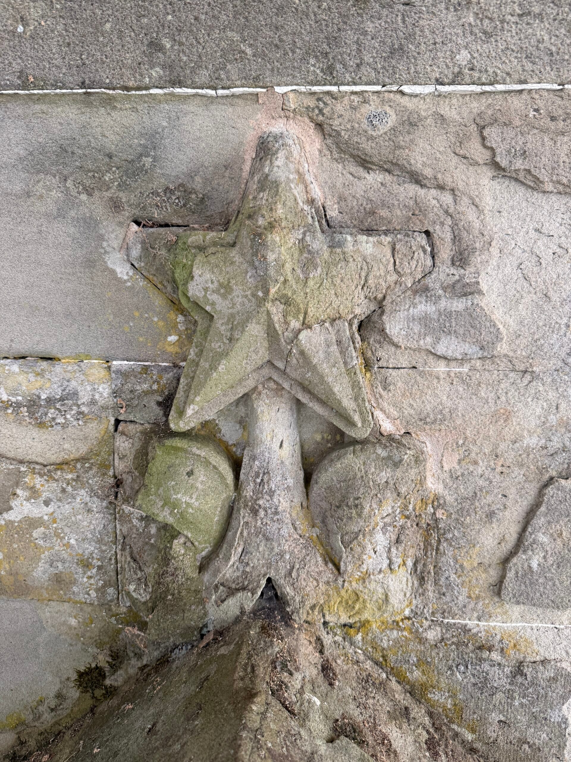 Two stars, two approaches. The original method, left, sees the surrounding stone carefully cut to fit around the five points of the star. The later approach, right, sets the complete star into a square stone panel, revealing how building and repair techniques at the Castle have evolved over time.